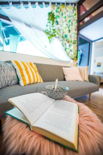 a table with two books and a candle on it at Boho House 3 camp Terme Catez with promotional tickets prices in Čatež ob Savi