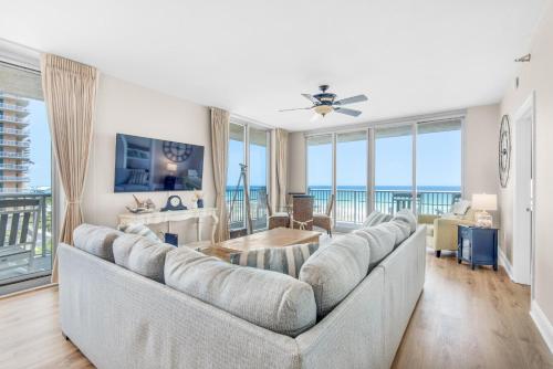 a living room with a large couch with a view of the ocean at Emerald Dolphin unit 610 in Pensacola Beach