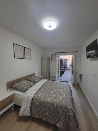 a bedroom with a large bed and a living room at Studio proche gare Vernon Giverny avec parking gratuit in Vernon