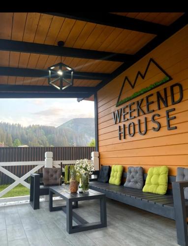 a patio with a couch and a welcome house at Weekend house in Verkhovyna