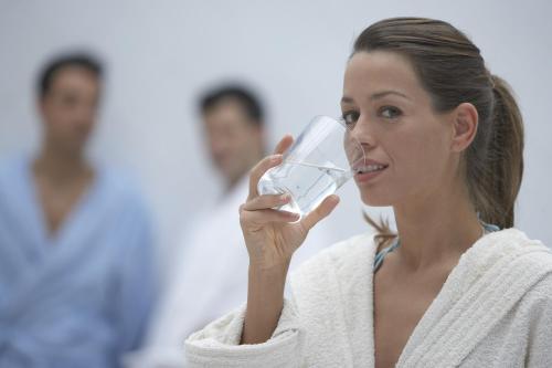 a woman drinking from a glass of wine at Balneario de Cestona in Zestoa