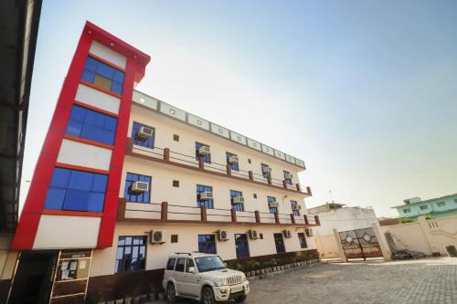 Itimādpur的住宿－Flagship 72863 New Satkar Hotel，停在大楼前的白色卡车