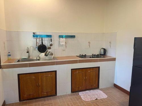 a kitchen with a sink and a counter top at Buddha Raksa in Thong Nai Pan Yai