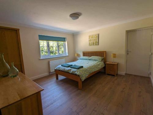 a bedroom with a bed and a window at The Hideaway in Woodhall Spa
