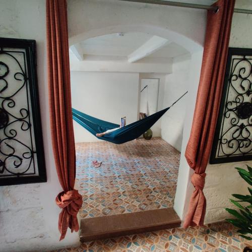 a mirror with a hammock in a room at Boho Rooms Sliema in Sliema