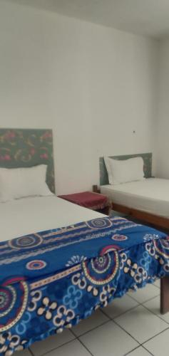 Ένα ή περισσότερα κρεβάτια σε δωμάτιο στο Hidayah homestay