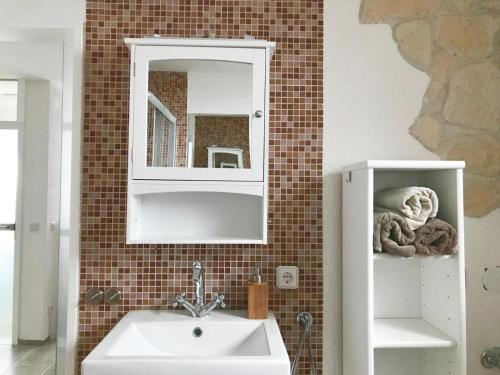 La salle de bains est pourvue d'un lavabo et d'un miroir. dans l'établissement Ferienapartment Laufen an der Eyach, à Albstadt