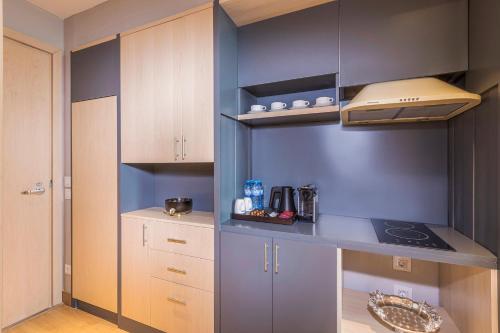 a kitchen with blue walls and a counter top at Hilton Garden Inn Samarkand Sogd in Samarkand