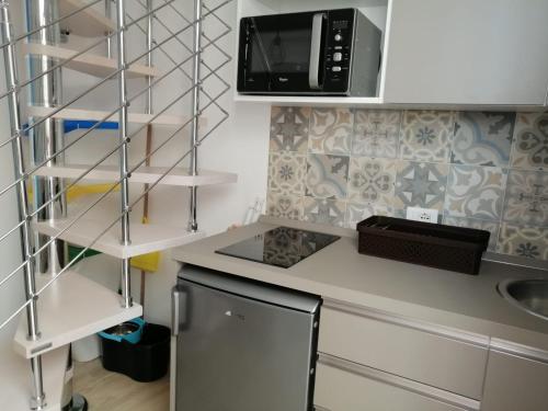 a kitchen with a counter top with a microwave at Casa dei Mulini in Favignana