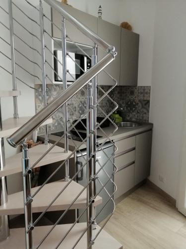 a metal spiral staircase in a kitchen at Casa dei Mulini in Favignana
