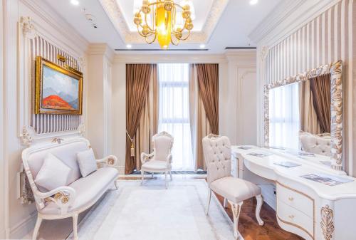 a white room with a table and chairs and a chandelier at Hilton Garden Inn Samarkand Sogd in Samarkand