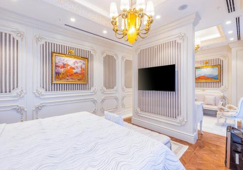 a bedroom with a bed and a flat screen tv at Hilton Garden Inn Samarkand Sogd in Samarkand