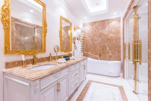 a luxury bathroom with a tub and a sink and a tubermott at Hilton Garden Inn Samarkand Sogd in Samarkand
