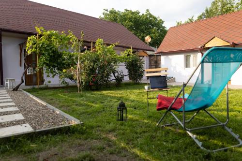 a yard with a swing set and a table and a house at Nomad Sud Studios in Town Center in Cahul