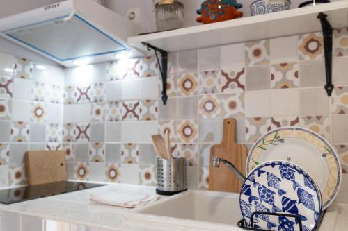 a kitchen with blue and white tiles on the wall at Nomad Sud Studios in Town Center in Cahul