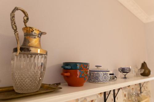 a shelf with a vase and other items on it at Nomad Sud Studios in Town Center in Cahul