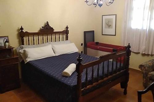 a bedroom with a large bed with a wooden frame at The Palm Villa rural beachside in Icod de los Vinos