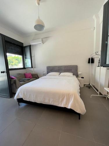 a bedroom with a large bed and a couch at no.21house studio apartment in Rio