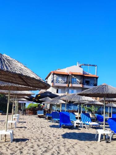a group of chairs and umbrellas on a beach at Troulis Seaside in Amoudara Herakliou
