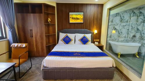 a bedroom with a bed and a bath tub in it at LA MIA Lakeview Hotel in Pleiku