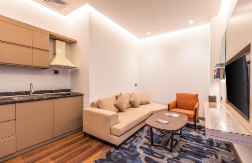a living room with a couch and a table at Wellness Park Hotel Bactria in Samarkand