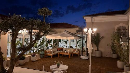 a house with an outdoor patio at night at Rasim Palas - Adults Only in Cesme