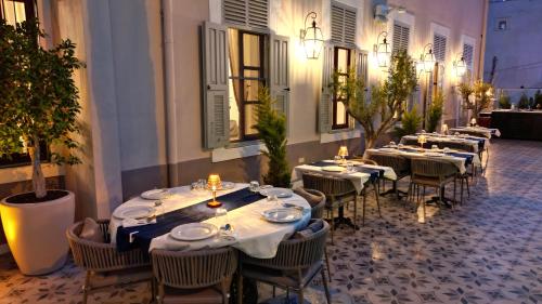 a row of tables and chairs in a restaurant at Rasim Palas - Adults Only in Cesme