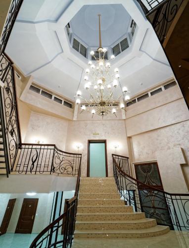 a large hallway with stairs and a chandelier at Svityaz Resort in Truskavets