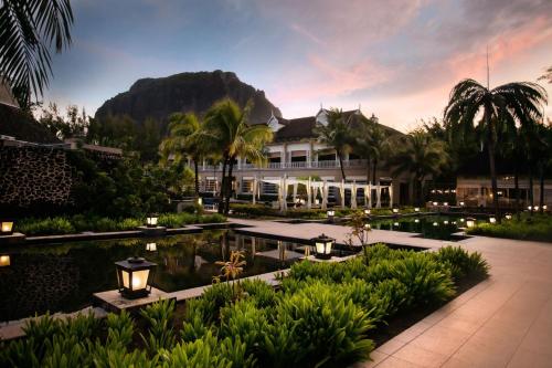 a resort with a pool and a mountain in the background at JW Marriott Mauritius Resort in Le Morne