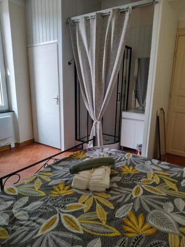 a bedroom with a bed with towels on it at chambre d'hôtes de Lamy 1 in Pierrerue