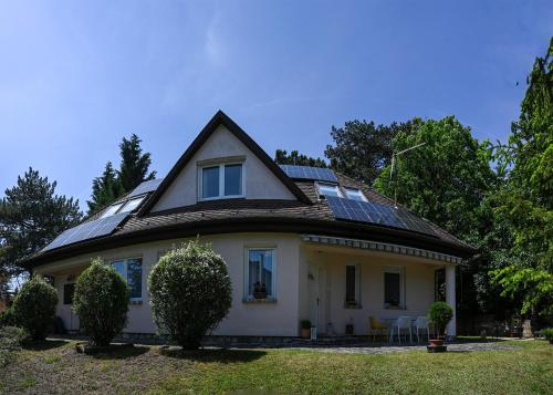 a house with solar panels on the roof at Kozmáry Vendégház in Matrafured