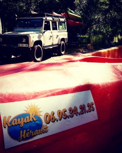 a white truck with a boat on top of a table at Cocon aux portes des Cévennes avec piscine in Moulès-et-Baucels