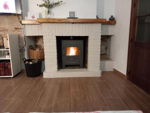 a brick fireplace in a living room with a fire place at La Casa del Abuelo Curro in Baños de la Encina
