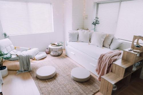 a living room with a white couch and a table at moof Osaka trendy spot Spacious Apt in Osaka