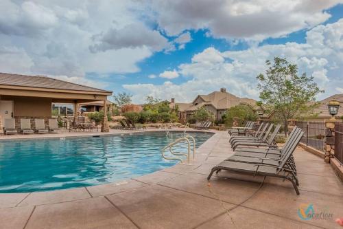 a swimming pool with lounge chairs in front of a house at Lost Springs-Relax and Enjoy! in Washington