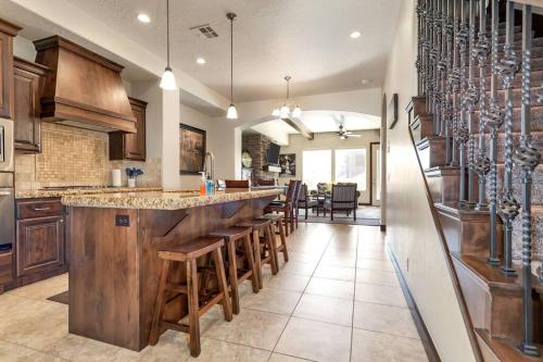 a large kitchen with a bar with wooden stools at Lost Springs-Relax and Enjoy! in Washington