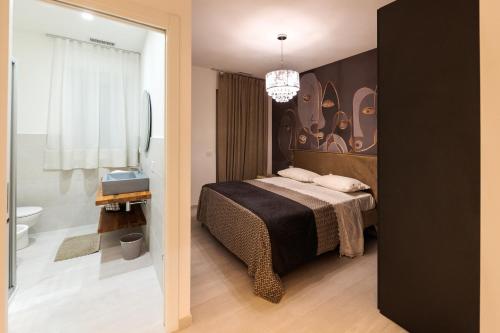 a bedroom with a bed and a bathroom at Centenarium Eco residenza in Porto SantʼElpidio