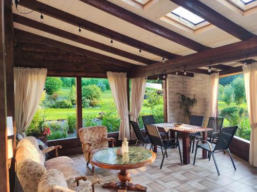 a living room with couches and a table and chairs at Dom Kowala in Jankowce