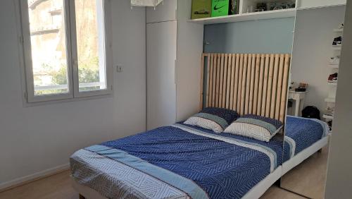 サン・ラファエルにあるAu grand calme, centre ville et la mer à piedの小さなベッドルーム(青い毛布と枕付きのベッド付)