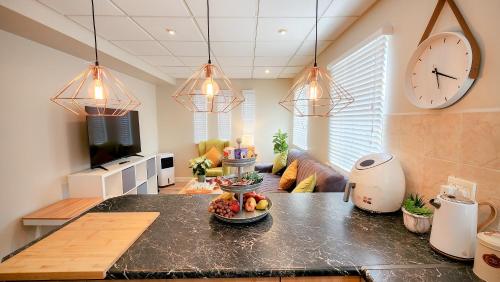 a kitchen with a table with a bowl of fruit on it at The Lazy Expat in Paarl