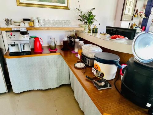 a kitchen with a counter with a coffee maker on it at Junyi Landscape Villa in Renai