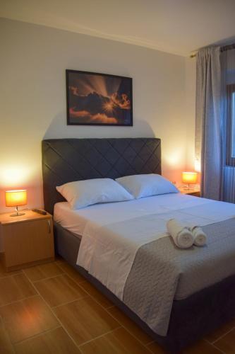 a bedroom with a bed with two towels on it at Apartmani Dina 1 in Posedarje