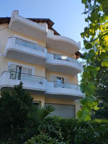 a building with balconies on the side of it at Serenity's Sunset Terrace in Shkodër