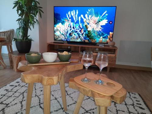 a living room with two wine glasses and a television at Marina Bella in Cogolin