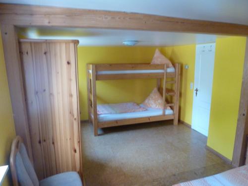 1 Schlafzimmer mit 2 Etagenbetten in einem Zimmer mit gelben Wänden in der Unterkunft Privatzimmer Rethaber in Ringsheim