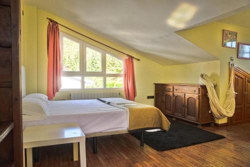 a bedroom with a large bed and a window at Villa del Mamut, Padul Granada in Padul