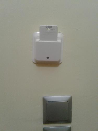 a white object on a wall next to aswitch at Καινούριο σπίτι σε ήσυχη τοποθεσία in Nafplio