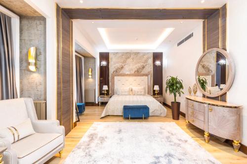 a bedroom with a bed and a couch and a mirror at Wellness Park Hotel Turon in Samarkand