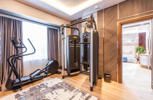 a room with a gym with a treadmill at Wellness Park Hotel Turon in Samarkand