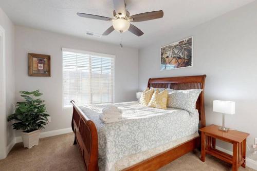 a bedroom with a bed with a ceiling fan at Southern Comfort-Pool! Hot Tub! in Washington